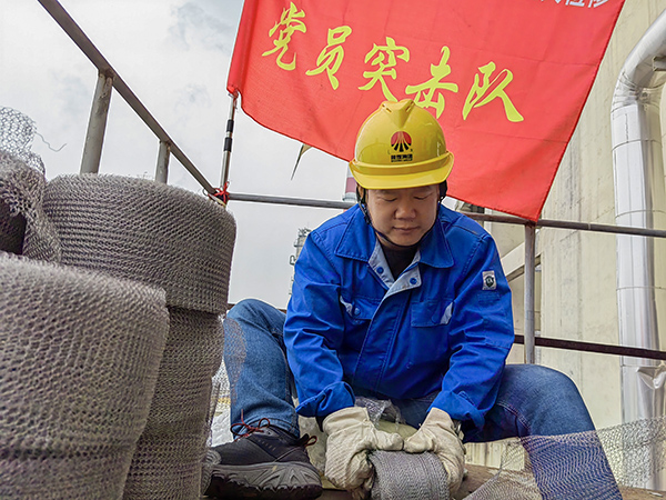 5月10日中午，在動(dòng)力車(chē)間三期工藝除氧器平臺(tái)上，黨員突擊隊(duì)隊(duì)長(zhǎng)李鑫正在纏繞新填料.jpg